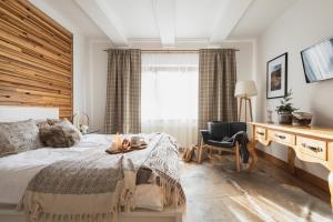a bedroom with a bed and a desk and a chair at Domek Amicus in Zakopane