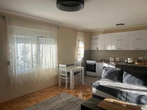 a living room with a table and a kitchen at Prestige in Podgorica