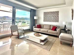 a living room with a couch and a table at Appartement du Bonheur - La Cala Resort in Mijas Costa