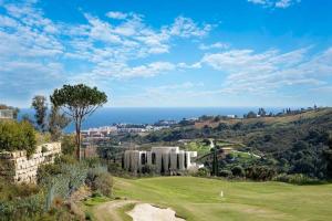 a golf course with the ocean in the background at Appartement du Bonheur - La Cala Resort in Mijas Costa