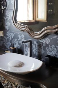 a bathroom with a white sink and a mirror at Vatellis Villas in Patitiri +90 photos
