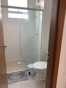 a small bathroom with a toilet and a shower at Cabedelo, lugar especial para você in Cabedelo +6 photos