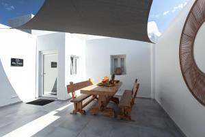 a dining room with a wooden table and chairs at Villa Izabela in Emporio