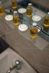 a glass counter top with bottles of honey on it at Vatellis Villas in Patitiri