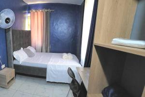 a small bedroom with a bed in a room at Mtwapa cosy 1 bed in Mtwapa