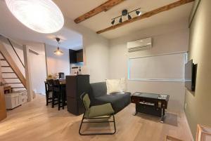 a living room with a couch and a table at Vacation House Tennoji 168, Osaka in Osaka