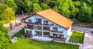 an aerial view of a house with an orange roof at Casuta Din Padure in Drăguş