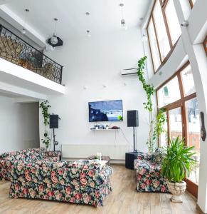 a living room with a couch and two chairs at Casuta Din Padure in Drăguş