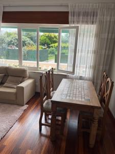 a living room with a table and chairs and a couch at Casa en el centro de Bezana in Santa Cruz de Bezana