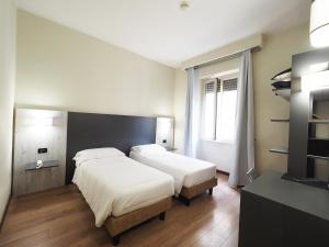 Voodi või voodid majutusasutuse Hotel Osimar toas