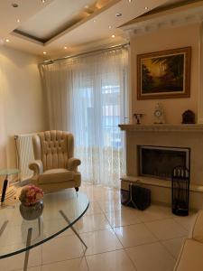 a living room with a chair and a fireplace at LaBelle Elite House in Aridaia,Lutra Pozar in Aridaia