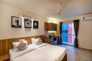 a bedroom with a large white bed and a bathroom at Wandr Hotel- Near MG Road in Bengaluru +44 photos