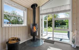a fireplace in a room with two windows at Nice Home In Tarm With Sauna in Tarm +30 photos