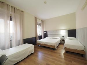 Voodi või voodid majutusasutuse Hotel Osimar toas
