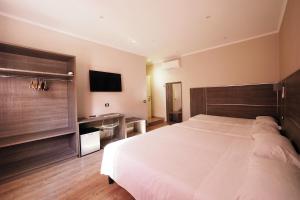 Voodi või voodid majutusasutuse Hotel Osimar toas