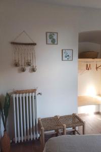 a room with a radiator and a table in a room at DORDOGNE 24 Chambre d'hôtes Jardin d'hiver Élégance Champêtre pour un séjour in Rouffignac Saint-Cernin +10 photos