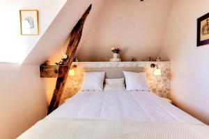 a bedroom with a white bed with two pillows at DORDOGNE 24 Chambre d'hôtes Romantique Élégance et Charme avec piscine au coeur du Périgord in Rouffignac Saint-Cernin +6 photos