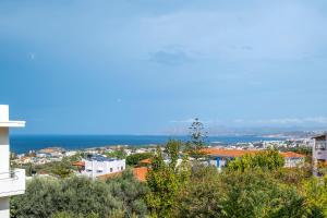 a view of the ocean from a building at Casa Chrysa Chania 1st floor house with amazing view in Galatás