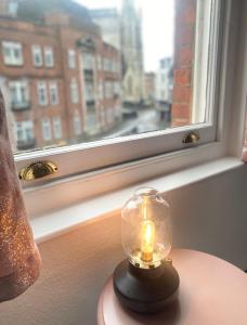 a candle on a table in front of a window at Urban Heights - Professionals, Contractors, Long Stays, 2Bed, Sleeps 4, Central Location, in Bournemouth