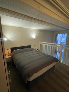 a bedroom with a large bed in a room at Stylish Mezzanine Apartment In Central Leeds in Central Station