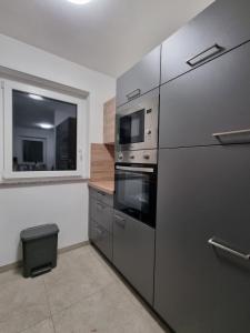 a kitchen with stainless steel appliances and a window at Apartma Termal Čatež - nastanitev z vključenimi 6-imi kopalnimi kartami - 6 tickets included in Čatež ob Savi