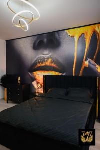 a bedroom with a large poster of a man with his mouth open at FLH - 777 Apartments in Bucharest
