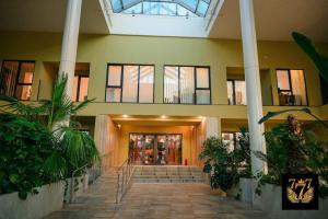 a lobby of a building with stairs and plants at FLH - 777 Apartments in Bucharest