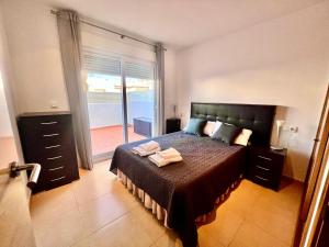 a bedroom with a bed and a door to a balcony at Condado De Alhama Naranjos 7 SV99 in El Romero +17 photos
