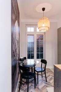 a dining room with a table and chairs and a window at Neptunus MB By the Ses Apartments OLD TOWN in Gdańsk