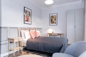 a bedroom with a bed and a table and chairs at Neptunus MB By the Ses Apartments OLD TOWN in Gdańsk +5 photos