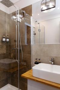 a bathroom with a sink and a shower at Neptunus MB By the Ses Apartments OLD TOWN in Gdańsk