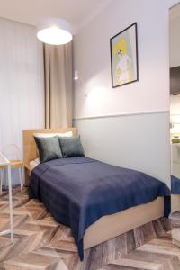 a bedroom with a bed with a blue blanket at Neptunus MB By the Ses Apartments OLD TOWN in Gdańsk