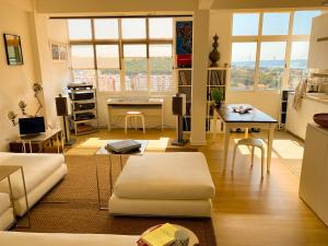 a living room with a couch and a table at Ideally located with perfect views in Algés