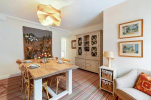 a living room with a table and a couch at The Coachhouse, East Budleigh , Sleeps 4 in East Budleigh