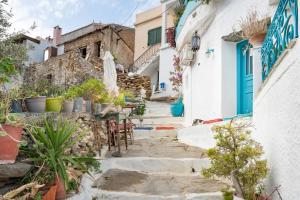 a small alley in positano with blue doors and chairs at The Castle House Kea in Ioulida