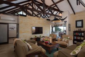 a living room with couches and a tv at Stella Road 24 in Ballito