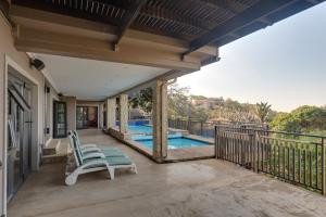 a patio with two chairs and a swimming pool at Stella Road 24 in Ballito