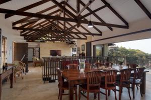 a dining room with a wooden table and chairs at Stella Road 24 in Ballito