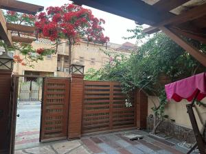 a wooden privacy fence with red flowers on it at room inside villa in Cairo