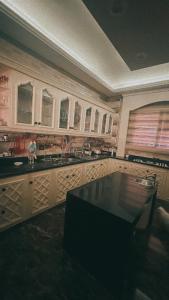 a kitchen with wooden cabinets and a large tub at room inside villa in Cairo