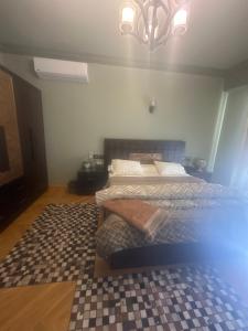 a bedroom with a bed with a checkered rug at room inside villa in Cairo +16 photos