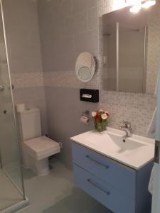 a bathroom with a sink and a toilet and a mirror at Schwarzwaldhotel Sonne in Baden-Baden