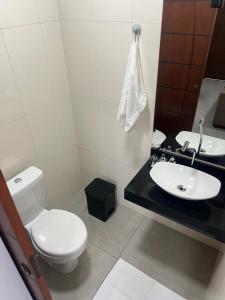 a white bathroom with a toilet and a sink at Sobrado confortavel e central in Foz do Iguaçu +24 photos