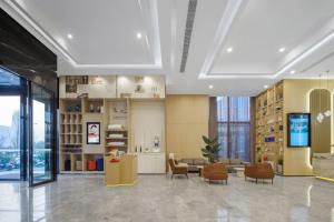 a large room with a lobby with chairs and tables at Atour Hotel (Xi'an Xiaozhainan, Qujiang Convention and Exhibition Center) in Xi'an