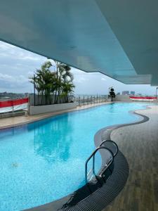 a swimming pool with a bench in a building at Studio Formosa Residence Batam By Skyline in Jodoh
