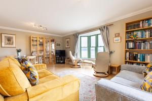 a living room with two couches and a dining room at 19 St Brides Bay in Haverfordwest