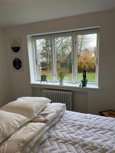 a bedroom with a bed in front of a window at Casa Home of Bricks 4 - Sleep next to LEGO HOUSE in Billund