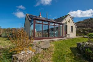 a house with large glass windows on the side of it at Agos Y Mor in Haverfordwest