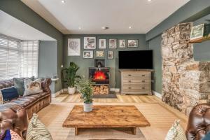 a living room with a couch and a fireplace at St Marys Hill Chapel in Tenby