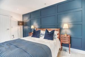 a blue bedroom with a bed with blue walls at St Marys Hill Chapel in Tenby